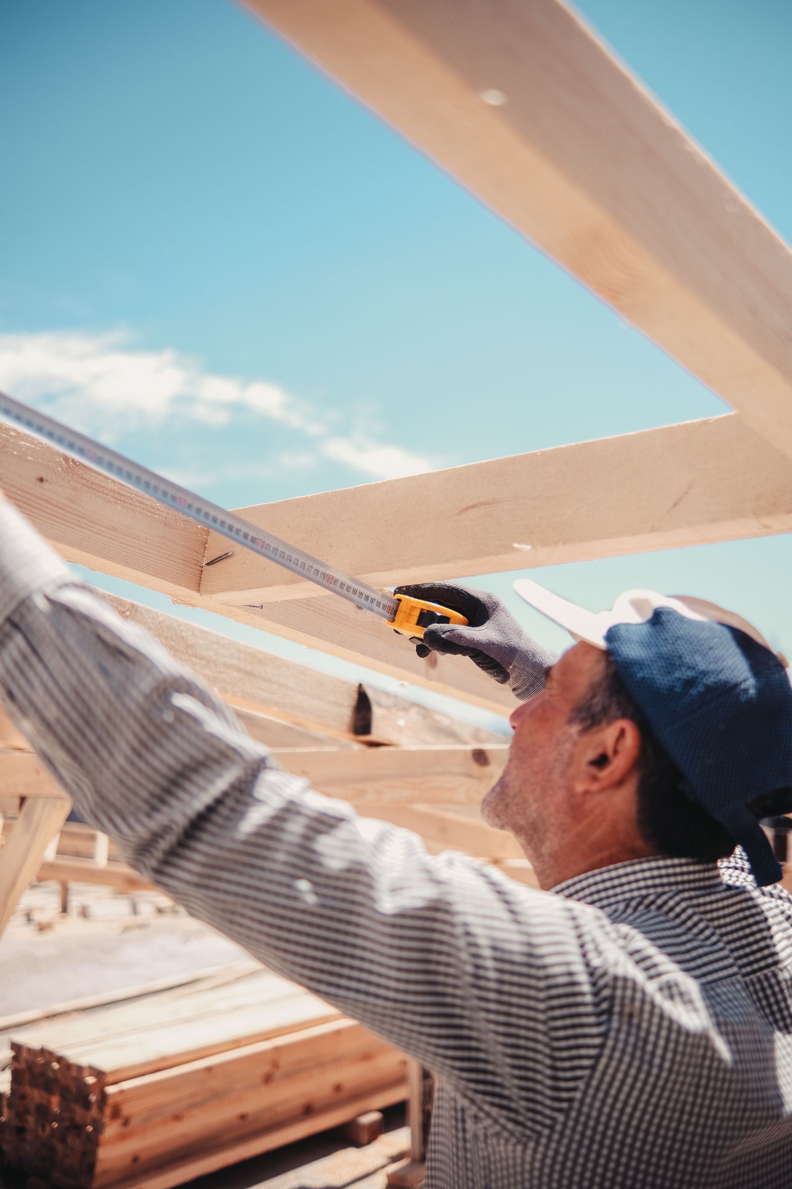 Contractor measuring lumber