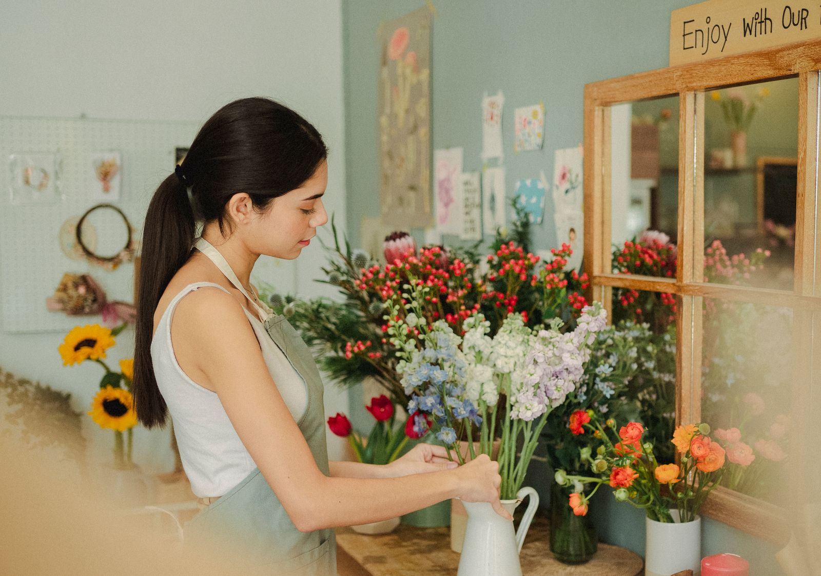 Florist arranging a bouquet in her shop